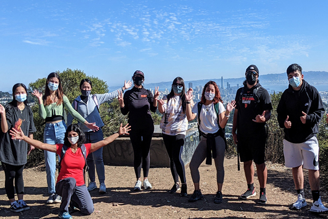 Group of students standing above San Francisco skyline