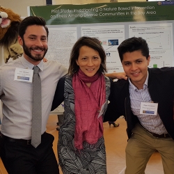 Edgar Velazquez, Eric Joshnon and Aiko Yoshino standing in front of a research poster.