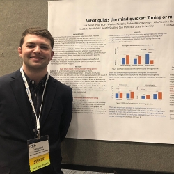 man standing in front of a poster presentation