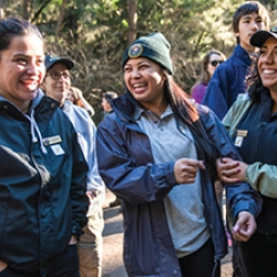 three women students outside laughing