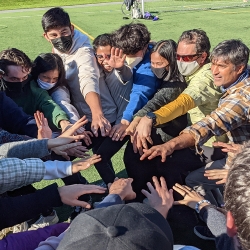 Group of students putting their hand together